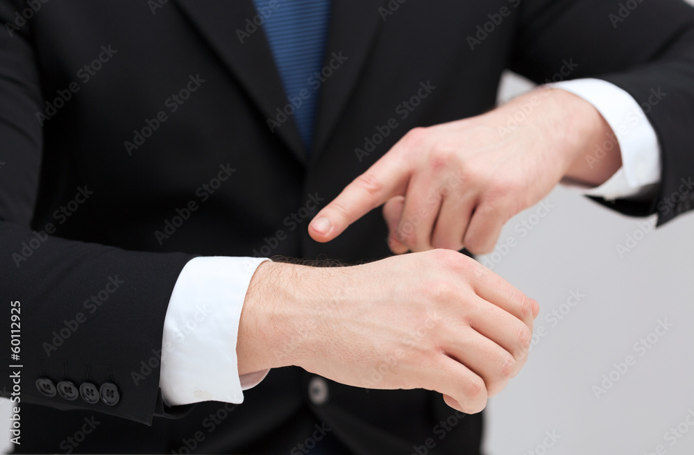 businessman pointing to something at his hand