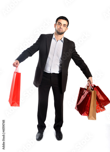man carrying sale shopping bags in stress
