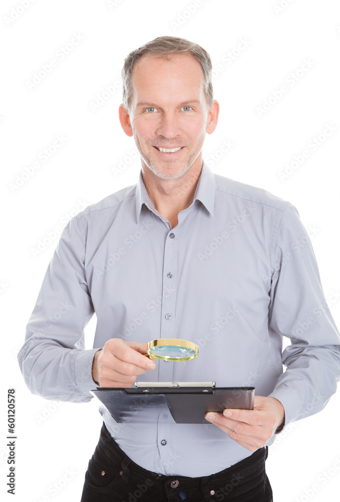 Looking At Clipboard Through Magnifying Glass Looking At Clipboard Through Magnifying Glass