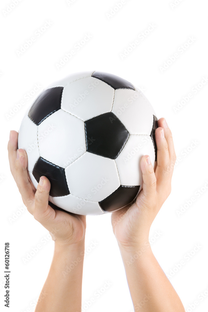 Human hand raising soccer ball