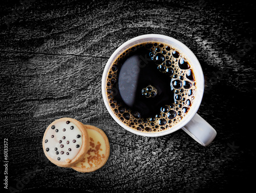 Cup of hot espresso coffee wiith biscuits