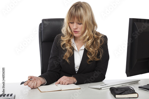 Attractive blond businesswoman working at a desk