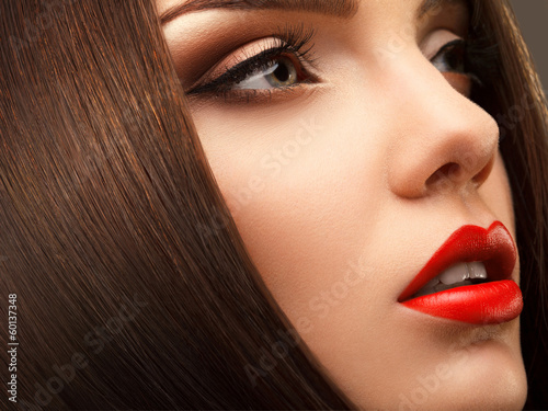 Fotografie Woman Eye with Beautiful Makeup. Red Lips. High quality image.