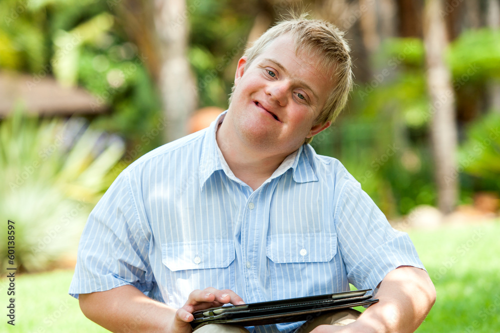 Boy wih down syndrome playing on tablet. Boy wih down syndrome playing on tablet.