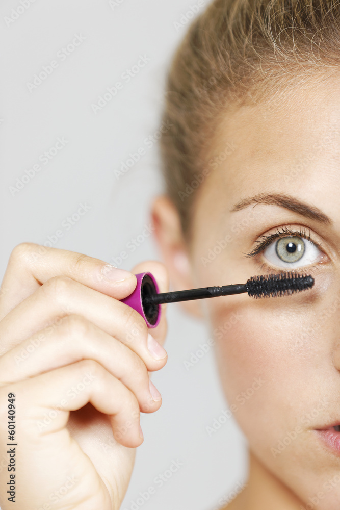 Woman applying make up