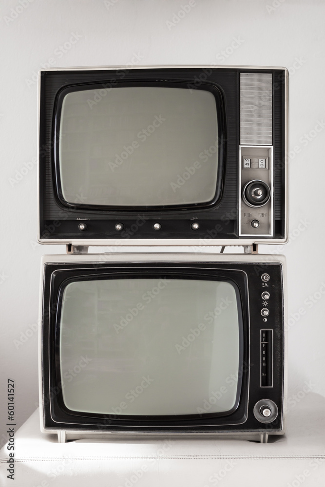 Two vintage televisions on white background
