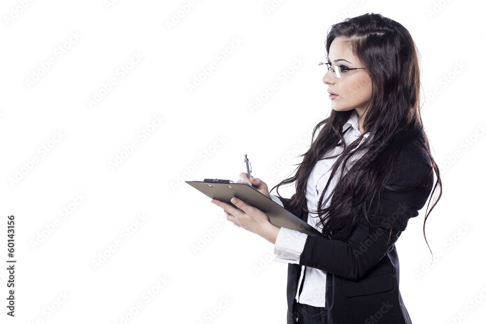 young serious business woman writing on her clipboard young serious business woman writing on her clipboard