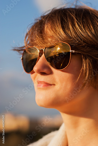 Close-up portrait of young woman in glases.