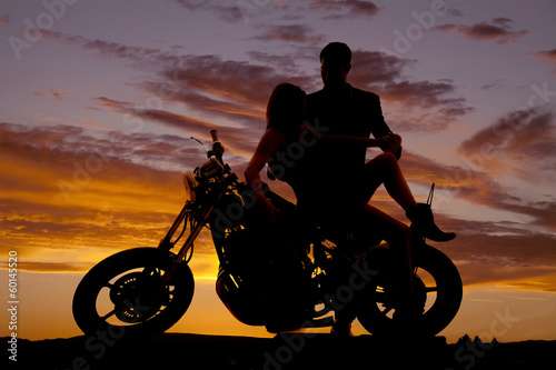 couple on motorcycle her lean back him hold