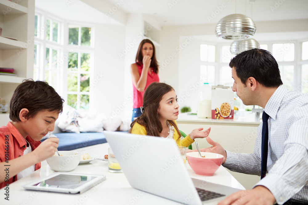 Family Using Digital Devices Having Argument Over Breakfast Family Using Digital Devices Having Argument Over Breakfast