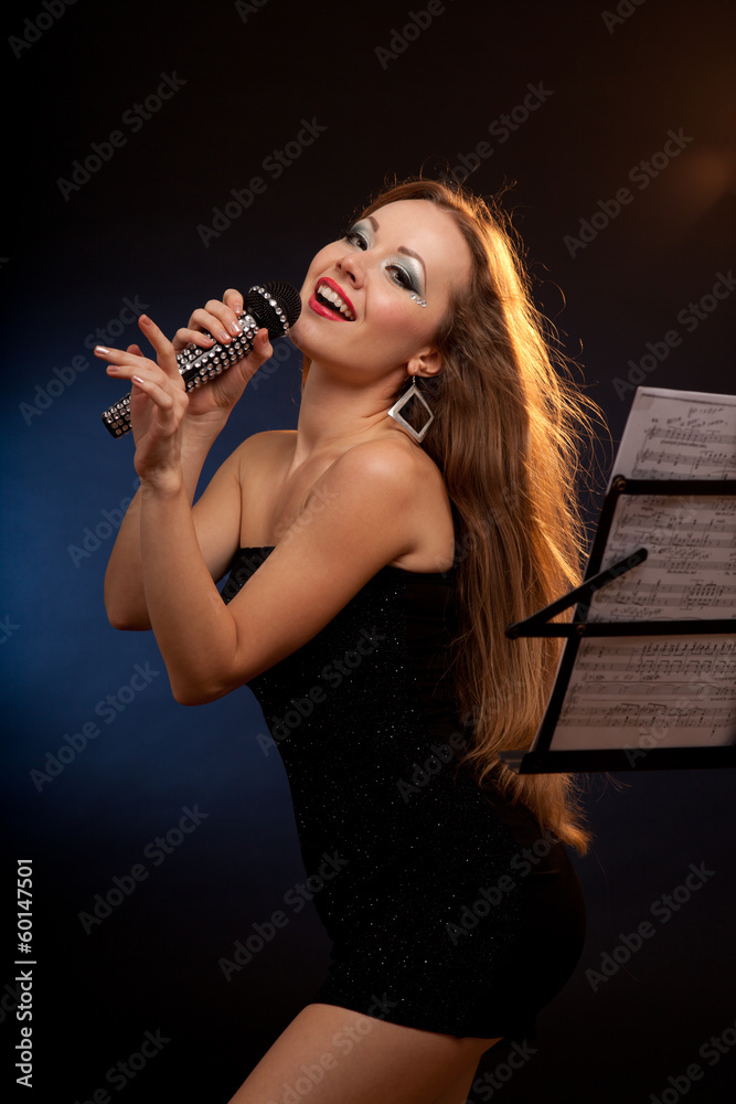 Portrait of a young beautiful woman in black dress singing Portrait of a young beautiful woman in black dress singing
