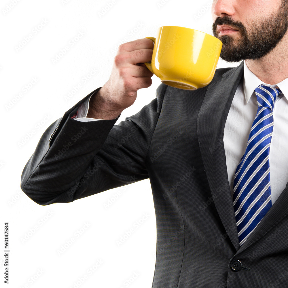 Young businessman drinking a coffee over white background Young businessman drinking a coffee over white background