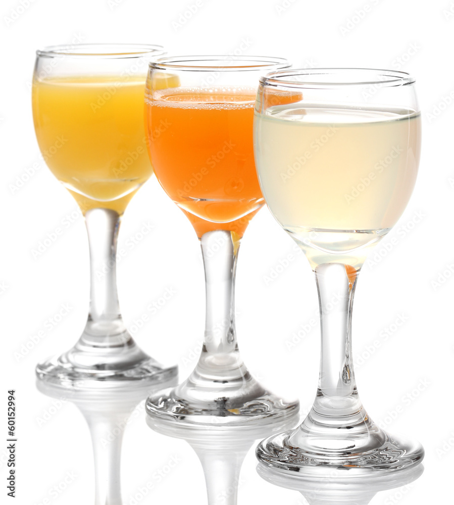 Tropical juices in glasses isolated on white Tropical juices in glasses isolated on white