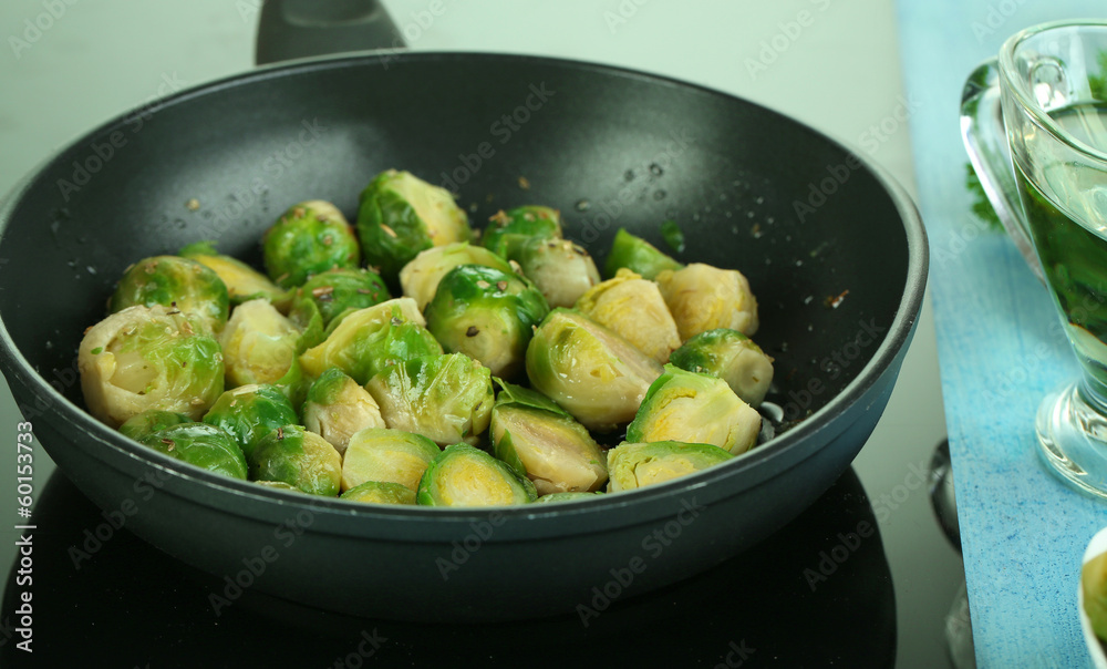 Fresh brussels sprouts in pan on cooking surface close-up Fresh brussels sprouts in pan on cooking surface close-up