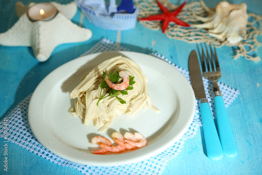 Pasta with shrimps on white plate, on wooden background Pasta with shrimps on white plate, on wooden background
