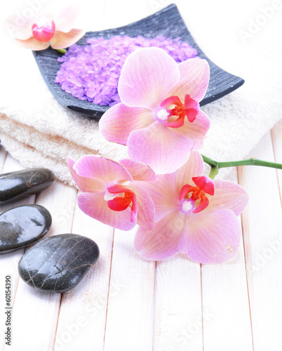 Still life with beautiful blooming orchid flower, towel and