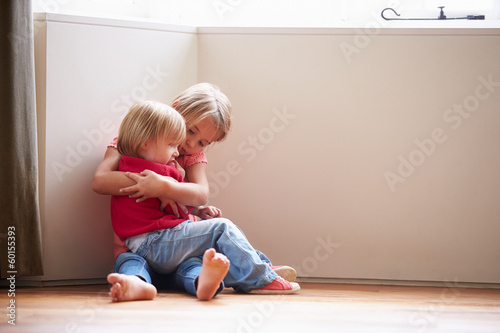 Φωτογραφία Unhappy Children Sitting On Floor In Corner At Home