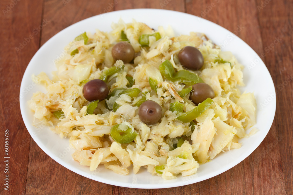 salad with codfish and vegetables on white plate salad with codfish and vegetables on white plate