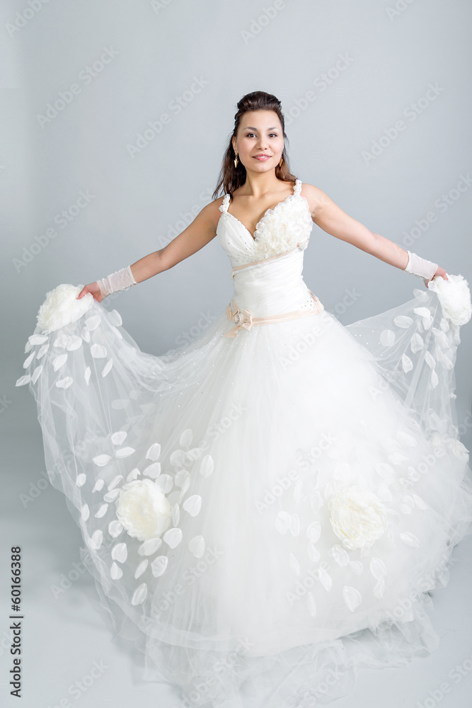 girl in a white wedding dress  waving hem