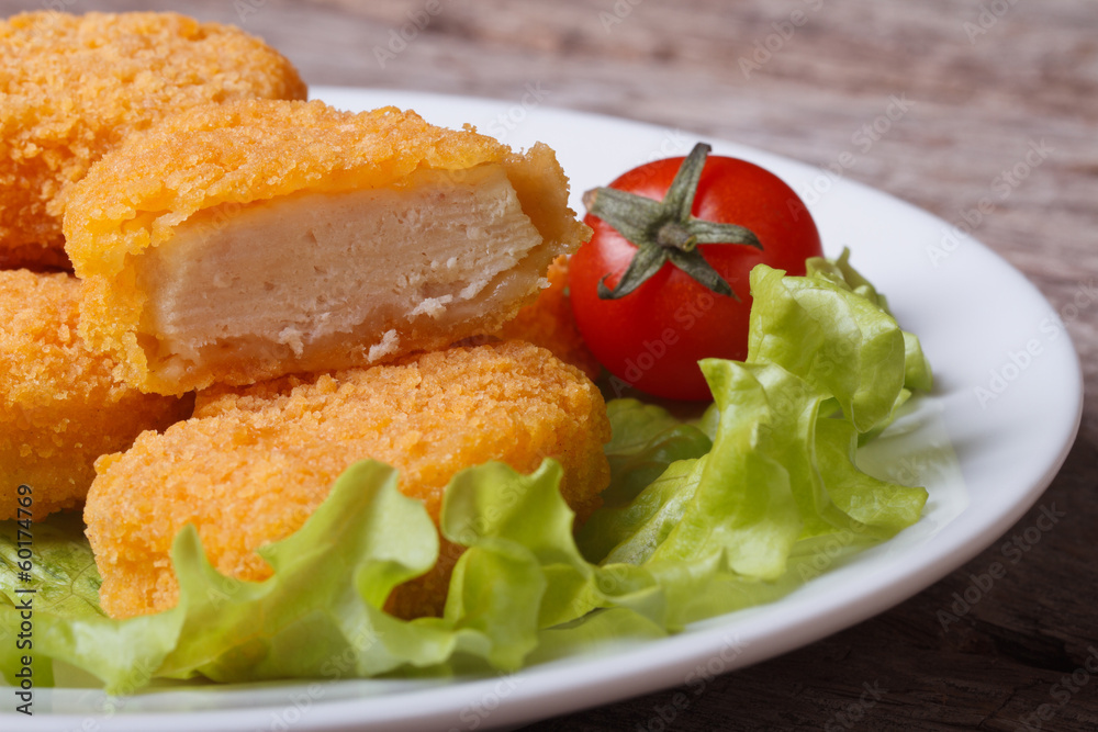 Sliced chicken nuggets, salad and cherry tomatoes Sliced chicken nuggets, salad and cherry tomatoes