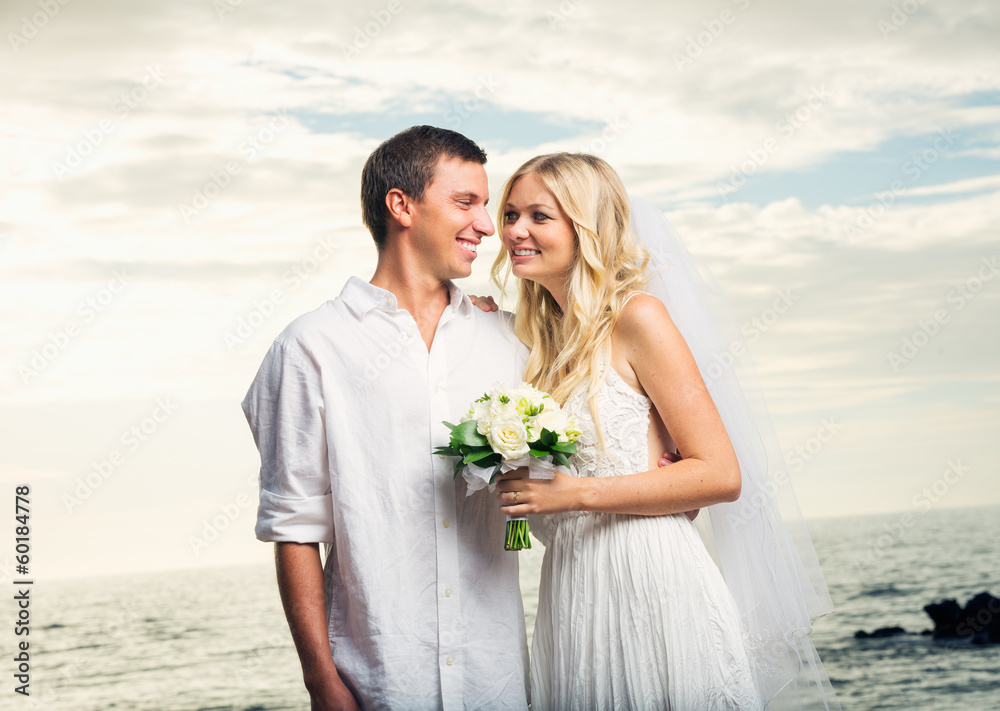 Married couple, bride and groom at sunset on beautiful tropical Married couple, bride and groom at sunset on beautiful tropical