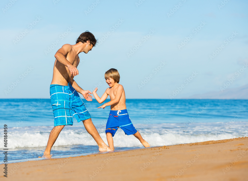 Happy father and son playing together at beach