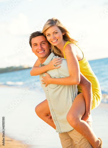 Attractive Couple Playing on the beach at Sunset © EpicStockMedia