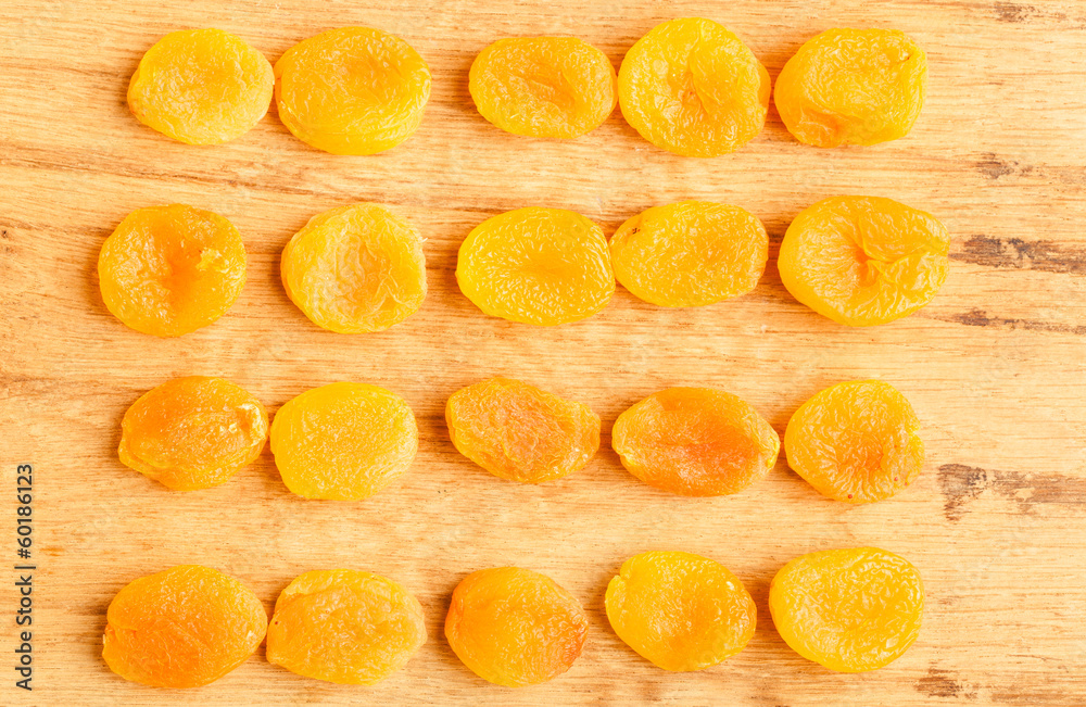 Dried apricots set on wooden table background.