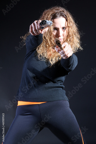 Curly sexy woman killer with handguns
