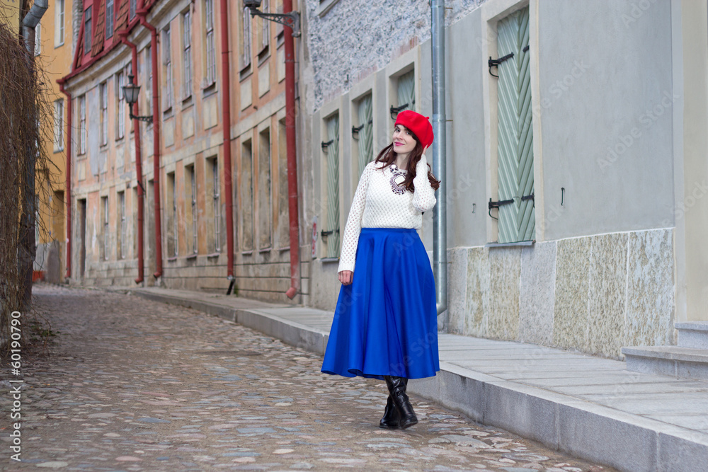 young beautiful woman walking in medieval town