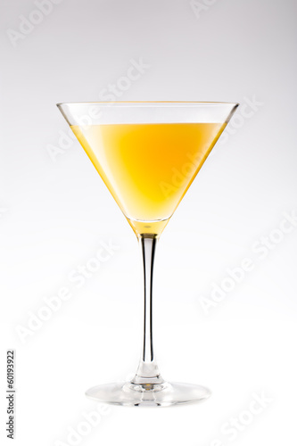 Orange cocktail in a martini glass isolated on white