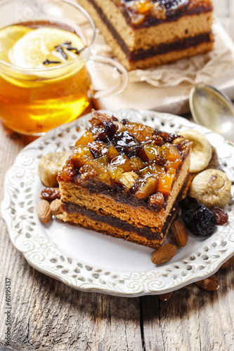Delicious layer gingerbread cake decorated with dried fruits