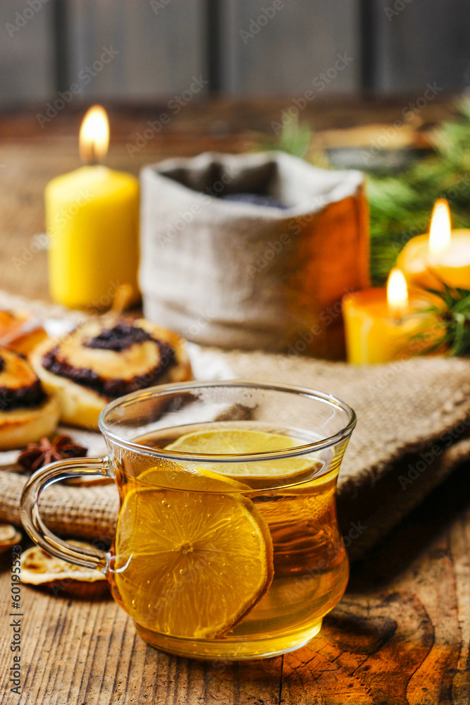 Cup of golden tea in evening candle light. Romantic atmosphere Cup of golden tea in evening candle light. Romantic atmosphere
