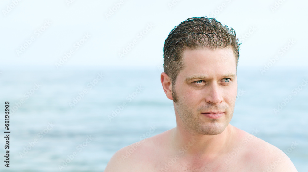 Fototapeta premium Attractive male portrait over sea background