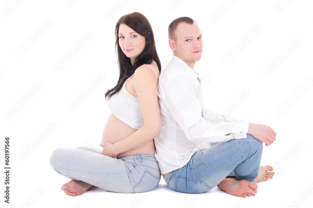Beautiful pregnant woman and her husband isolated over white Beautiful pregnant woman and her husband isolated over white