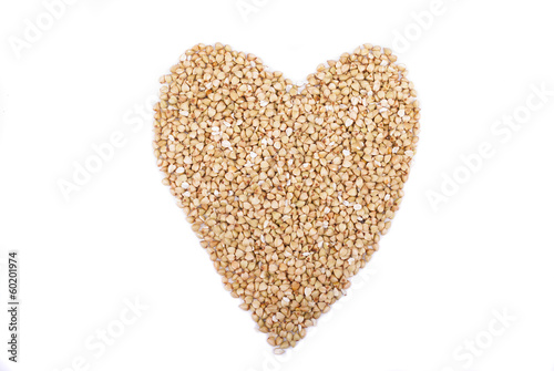 buckwheat groats in shape heart Isolated on white background