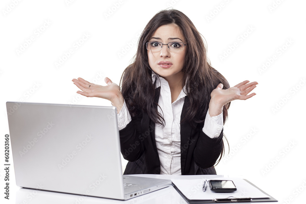 confused and beautiful young business woman at the desk confused and beautiful young business woman at the desk