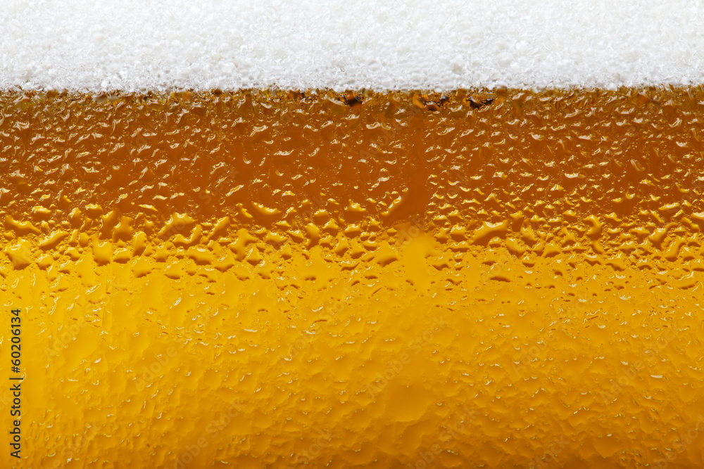 Close-up picture of a beer with foam and bubbles Close-up picture of a beer with foam and bubbles
