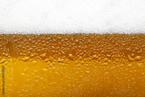 Close-up picture of a beer with foam and bubbles