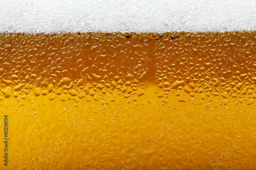Close-up picture of a beer with foam and bubbles