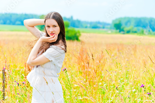 beautiful woman posing in a field of flowers