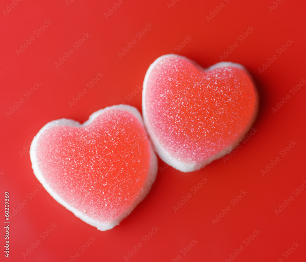 Sugar hearts on red background