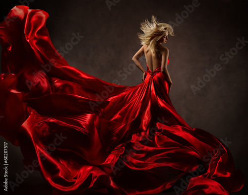 Woman in red waving dress with fluttering flying fabric Fototapet