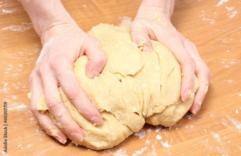 Hand of woman kneading dough for yeast cake Hand of woman kneading dough for yeast cake