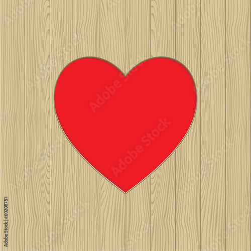 Hole in heart shape on wooden texture