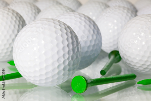 Many golf balls on a glass table