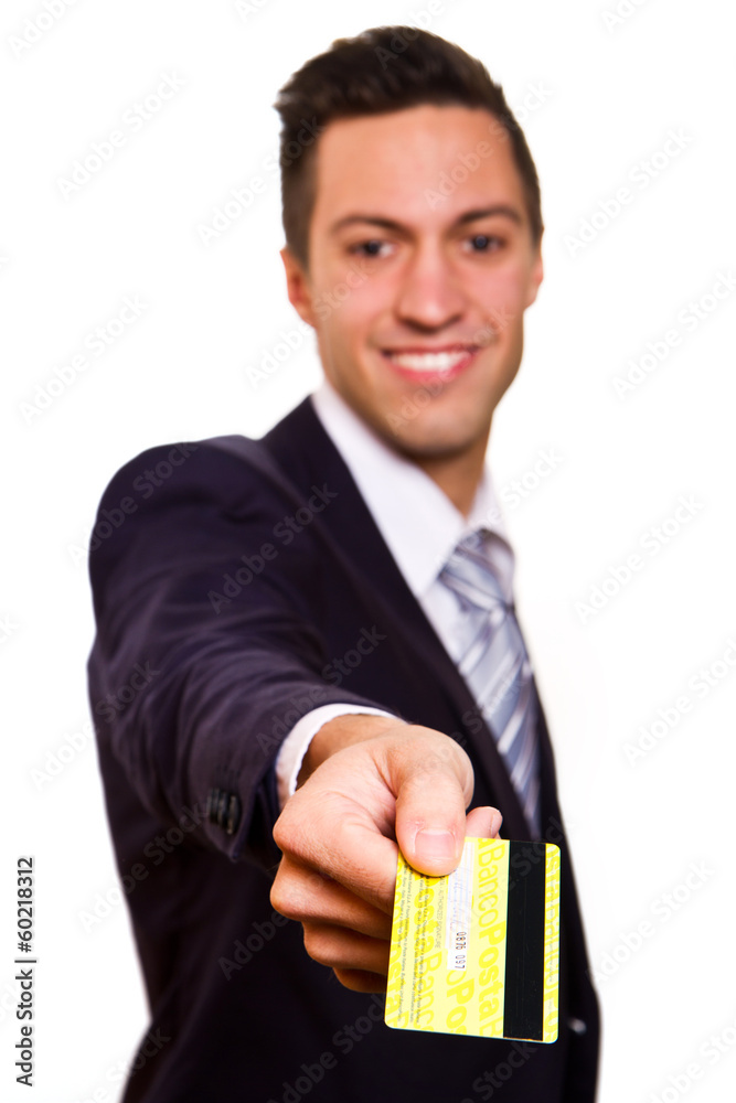 Happy smiling young man holding a credit card isolated on white Happy smiling young man holding a credit card isolated on white
