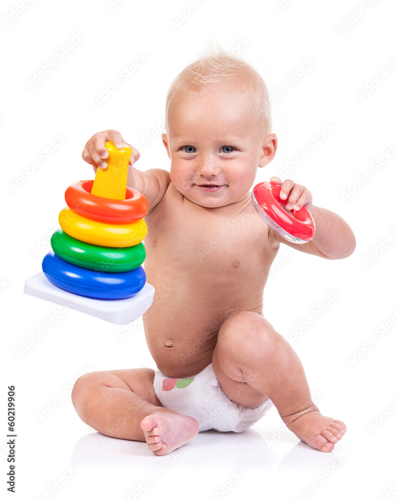 Cute little boy playing with pyramid toy over white background Cute little boy playing with pyramid toy over white background