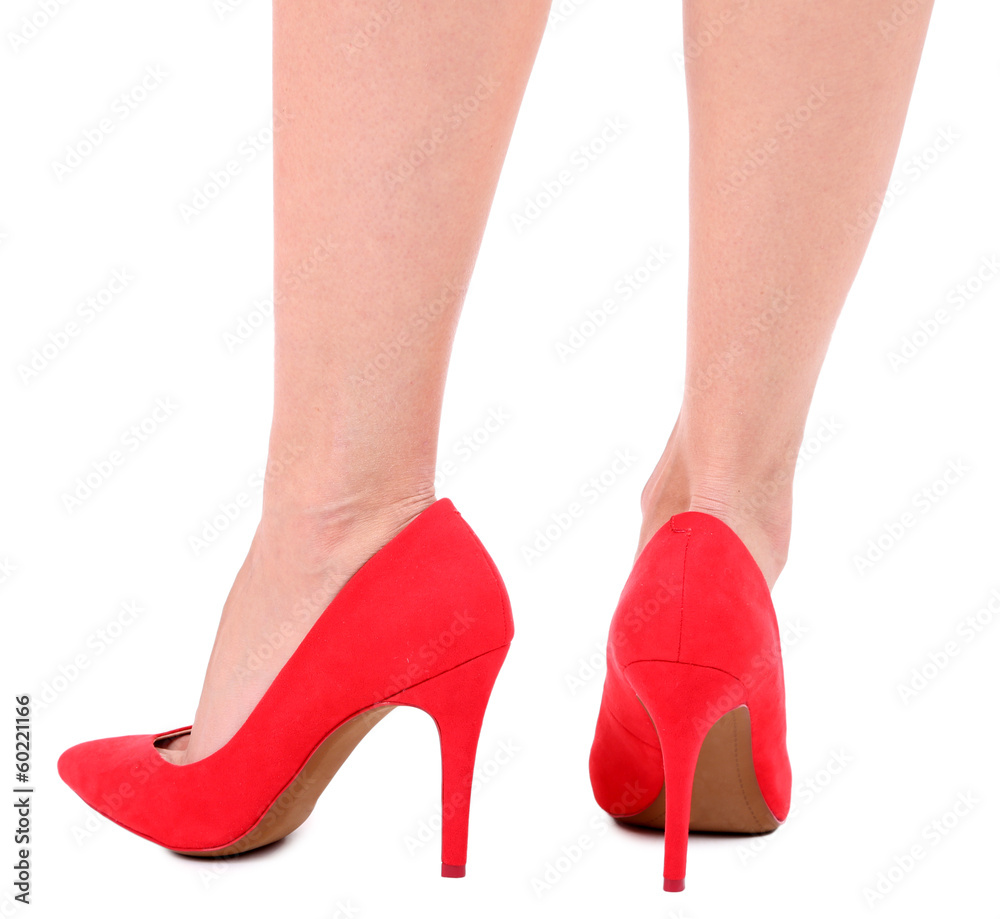 Beautiful female legs in red shoes isolated on white Beautiful female legs in red shoes isolated on white