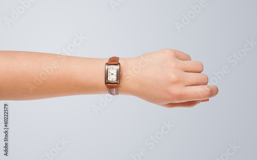 Hand with watch showing precise time